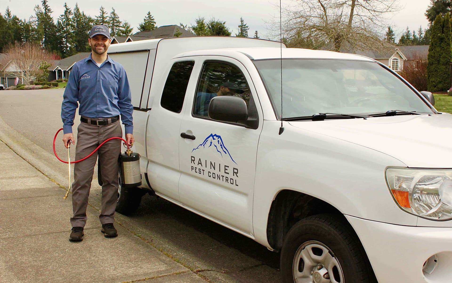 Owner standing in front of his pest control truck